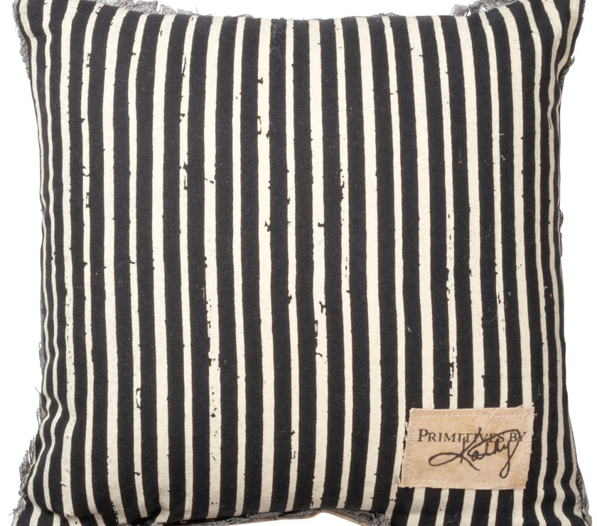 Striped pillow with black and white pattern and a visible brand label on a white background