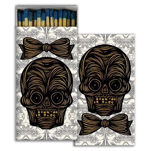 Matches with gold skull and bow design on a decorative box