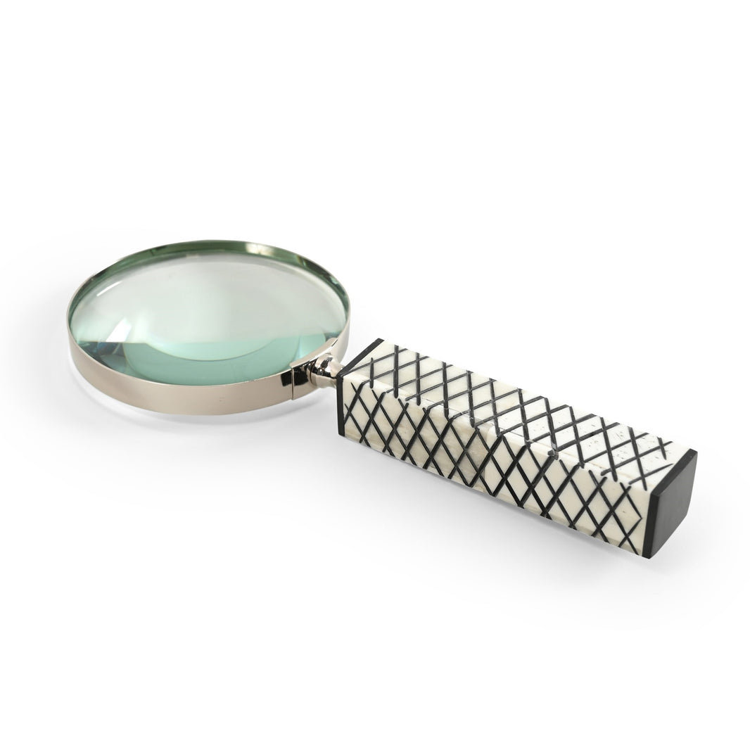 Magnifying glass with a textured handle on a white background