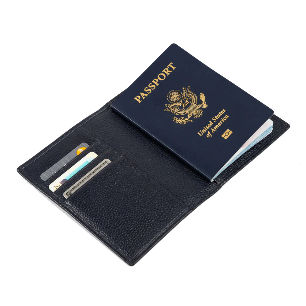 Dark blue leather passport holder with a U.S. passport and credit cards inside on a white background