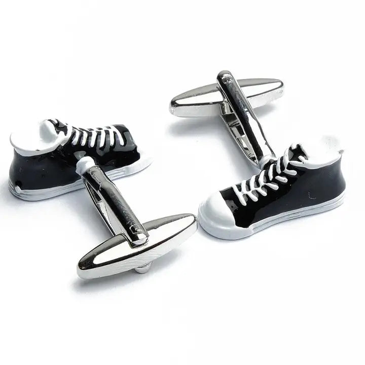 Black and white sneaker-shaped cufflinks on a white background
