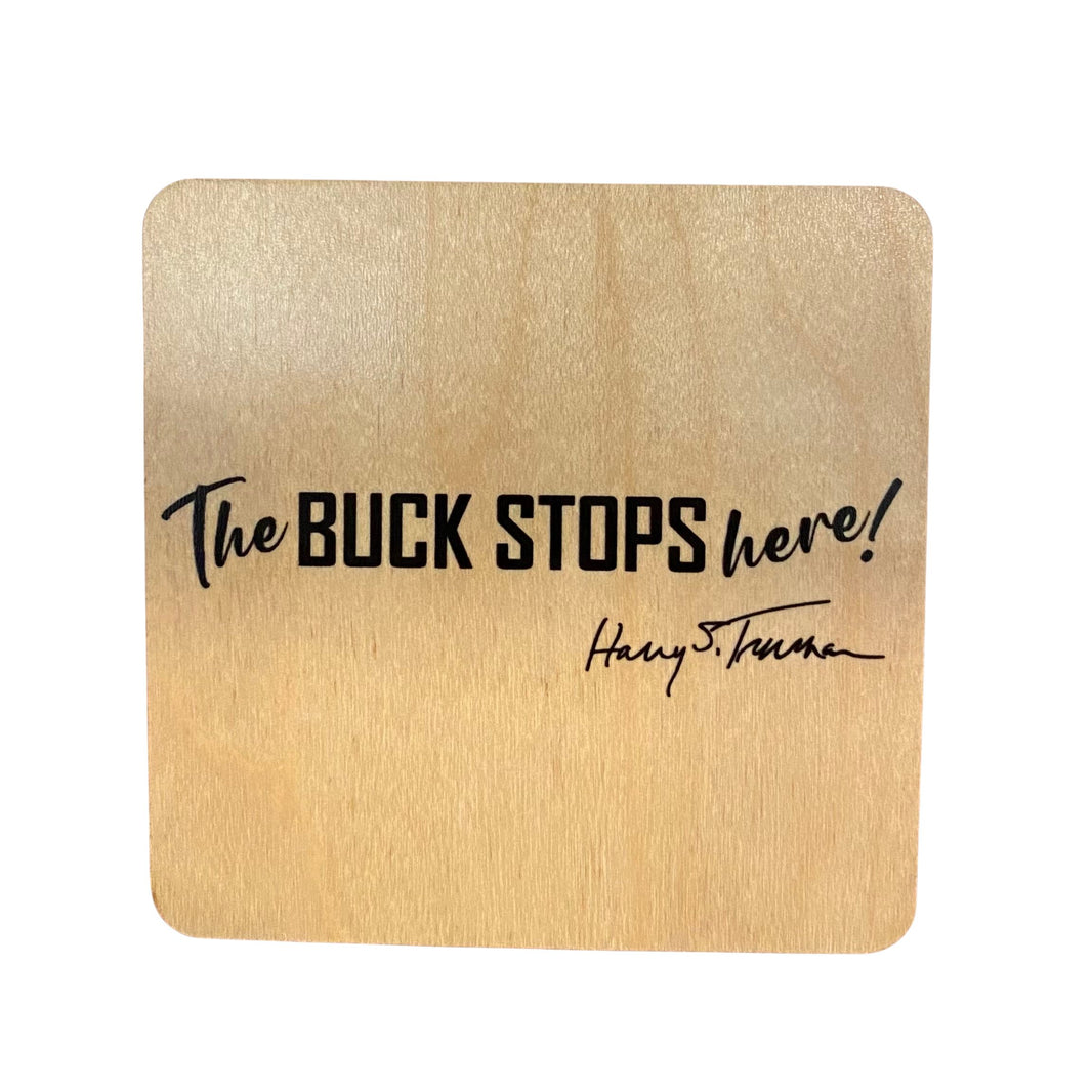 Wooden magnet with 'The Buck Stops Here!' quote on a white background