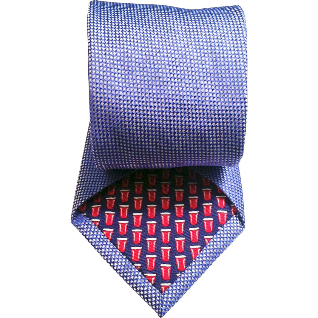Blue patterned tie with a red and white design on a white background