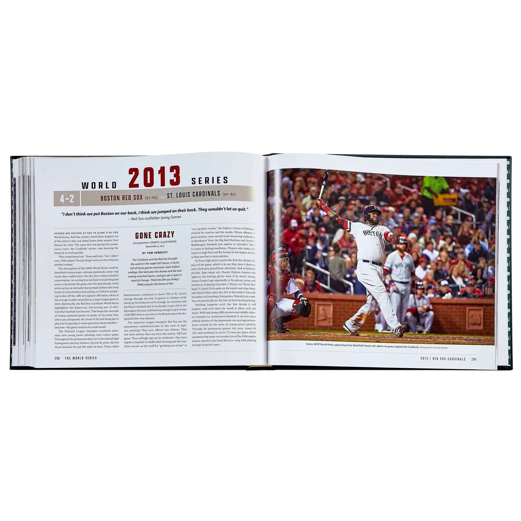 An inside look at a commemorative book of 'The World Series' by Sports Illustrated, open to the chapter focusing on the 2013 World Series with text and an image of players mid-play.