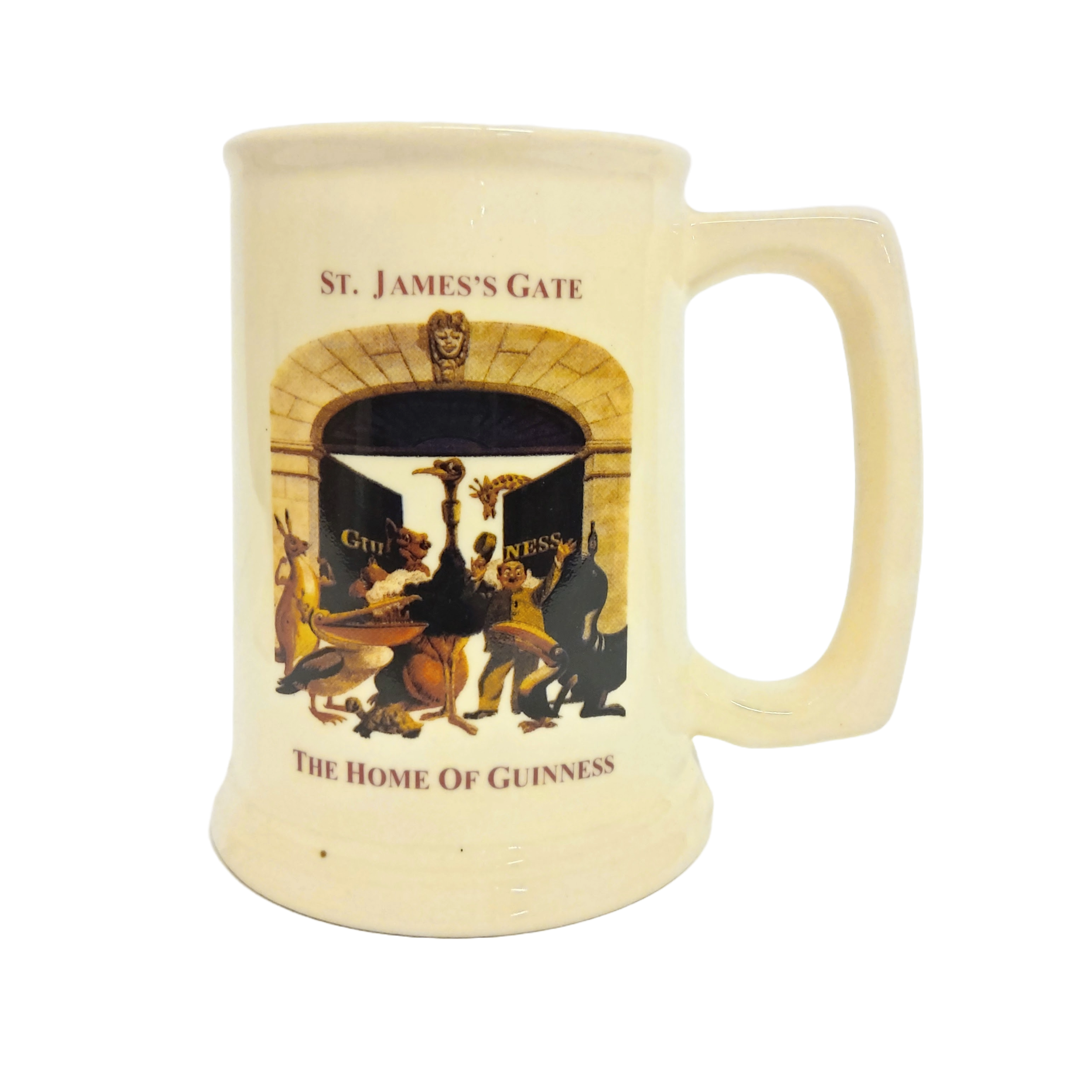 A beige ceramic beer stein with a decal of St. James Gate and the 'Home of Guinness' text.