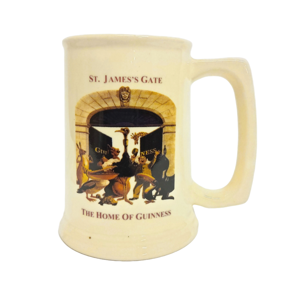 A beige ceramic beer stein with a decal of St. James Gate and the 'Home of Guinness' text.