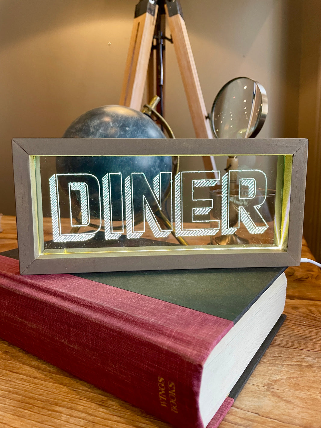 Light-up sign with 'DINER' on a book