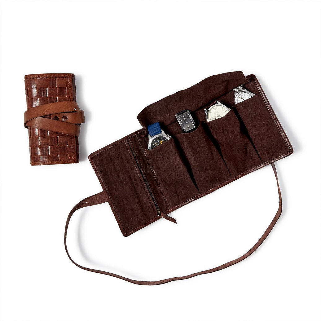 Brown leather roll-up watch case with straps on a white background