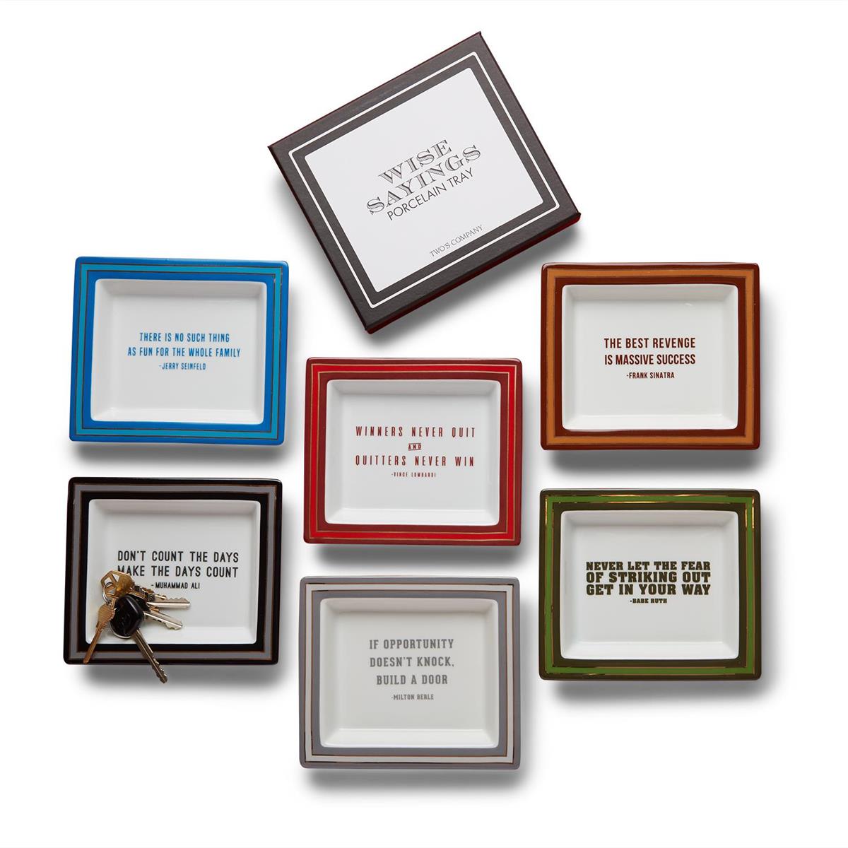 A collection of porcelain desk trays with various colorful frames and each featuring a different quote. They are displayed on a white background.