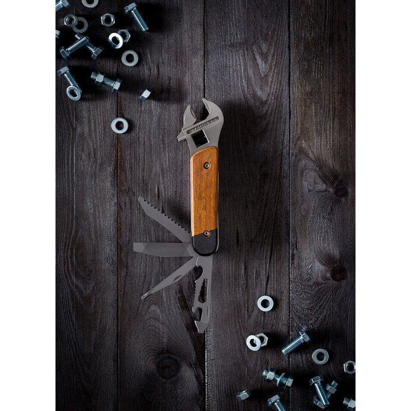Multitool with wooden handle and knife blade on a wooden surface with screws and bolts.