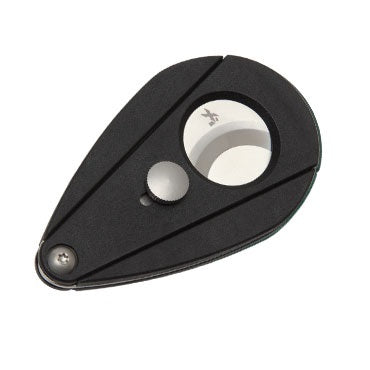 A black Xi2 cigar cutter with a carbon fiber-like pattern, featuring a blade and a cap, designed to cut cigars.