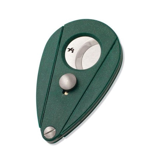 A green Xi2 cigar cutter with a carbon fiber-like pattern, featuring a blade and a cap, designed to cut cigars.