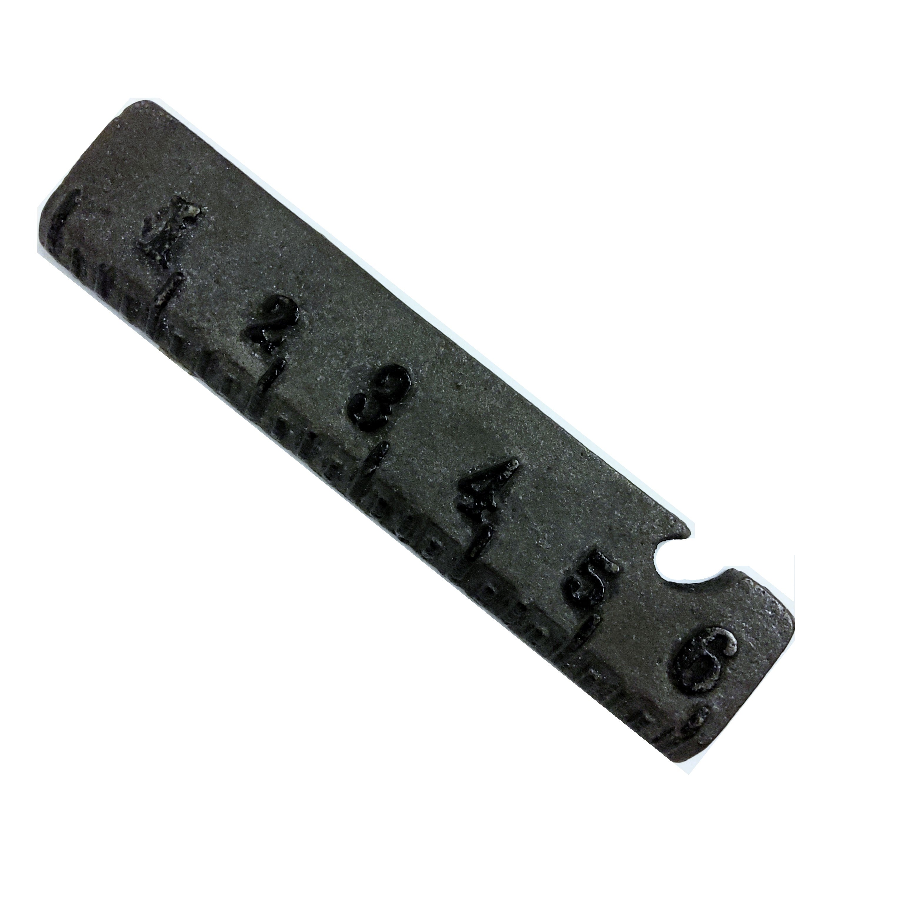 A black cast iron ruler bottle opener with measurement markings.