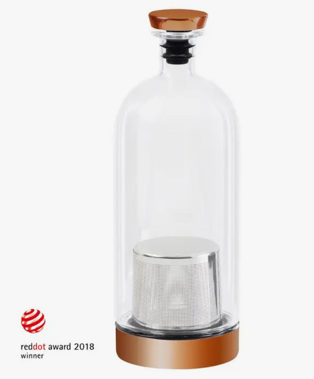 Glass and copper infusion vessel with a mesh strainer inside.