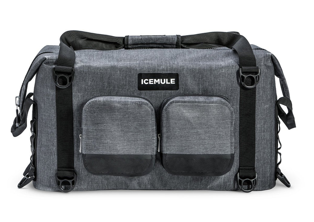 A gray Ice Mule Traveler soft cooler with a black top zipper and side straps, featuring a front pocket and the Ice Mule logo.