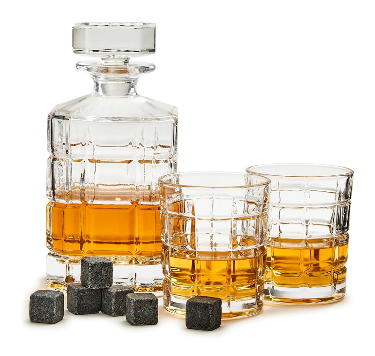 A connoisseur set that includes a glass liquor decanter with liquor in it, two rocks glasses with liquor, and whiskey stones