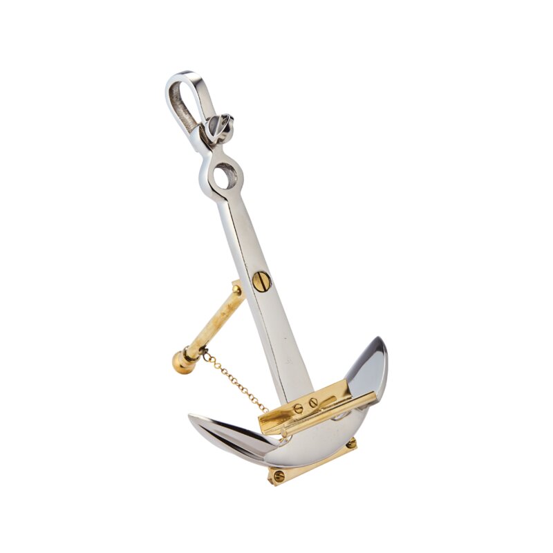 A decorative anchor-shaped stand, with gold and silver colors, designed to hold items such as phones or photos.