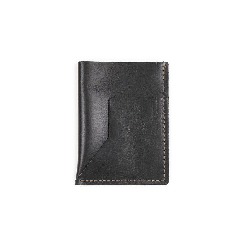 A black leather passport sleeve on a white background.