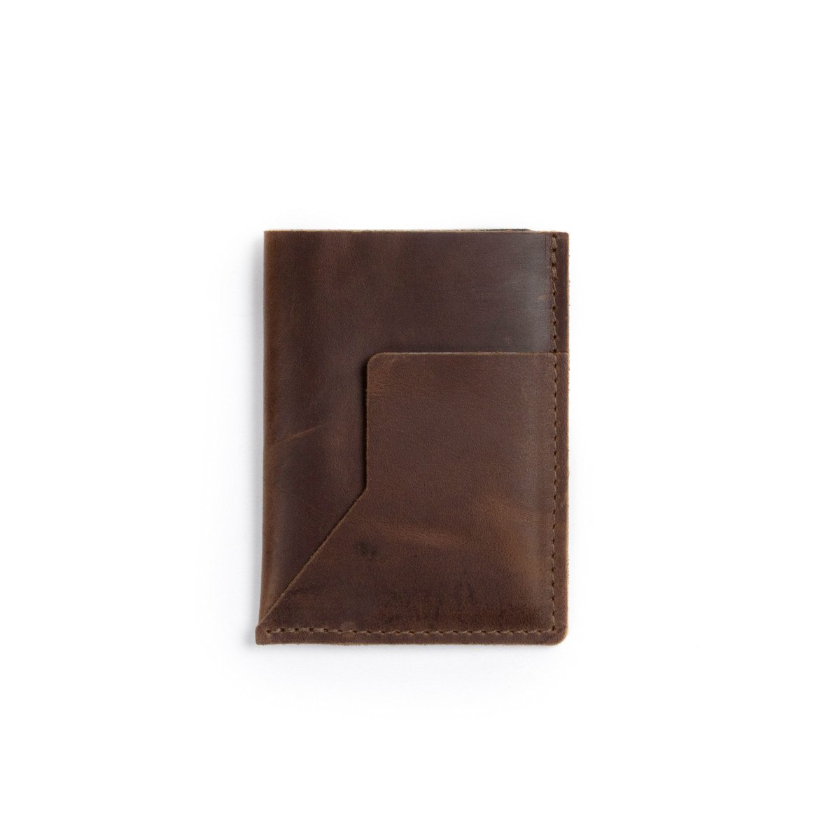 A brown leather passport sleeve on a white background.