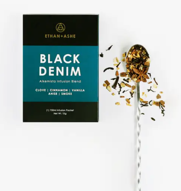 A package of 'Black Denim' Alkemista Infusion Blend by Ethan+Ashe with ingredients like clove, cinnamon, vanilla, and black cardamom displayed on a white background.
