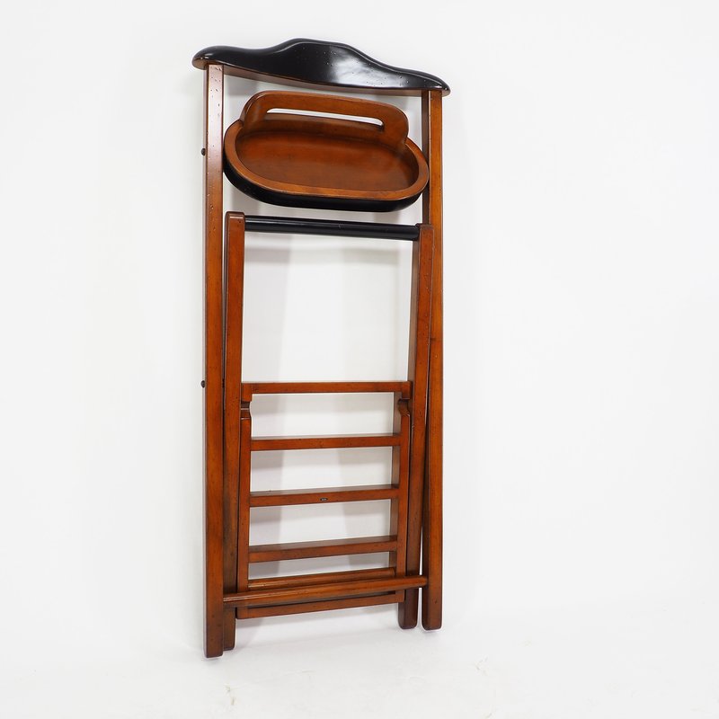 A butler's buddy clothing and shoe rack folded up on a white background