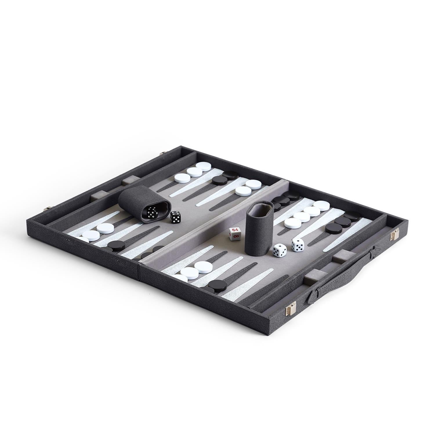 An open backgammon set with checkers and dice cups arranged on the board, made of vegan leather and wood.