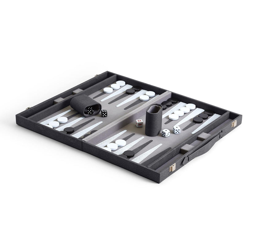 An open backgammon set with checkers and dice cups arranged on the board, made of vegan leather and wood.