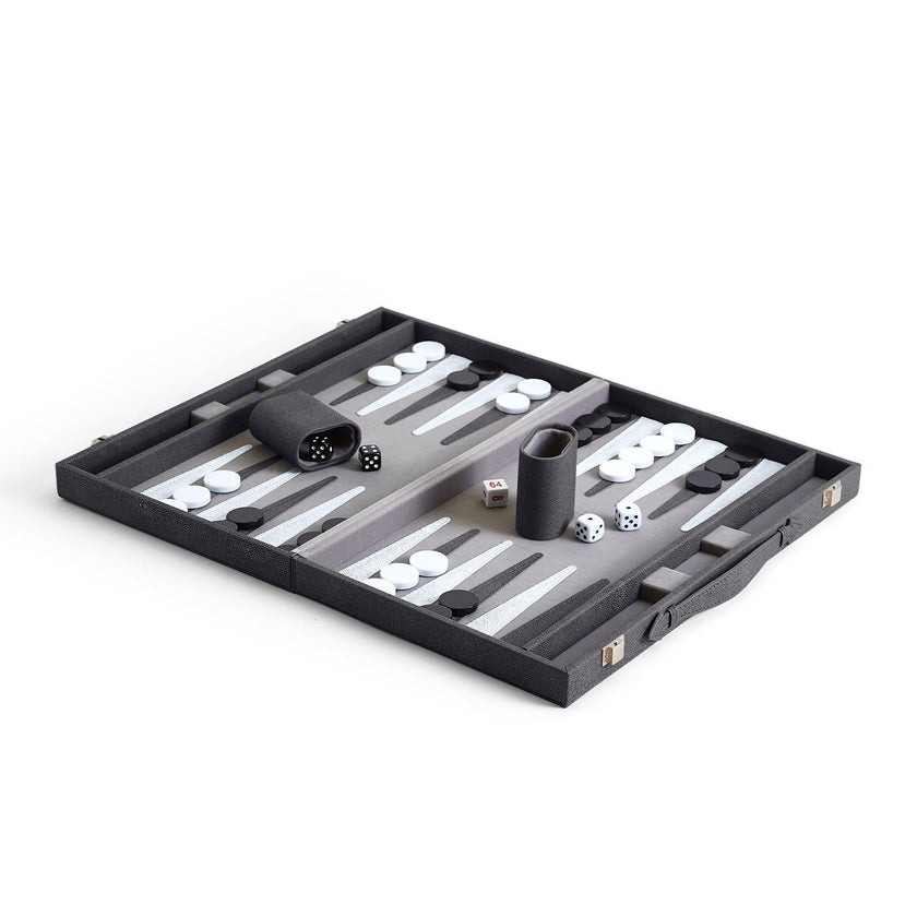 An open backgammon set with checkers and dice cups arranged on the board, made of vegan leather and wood.