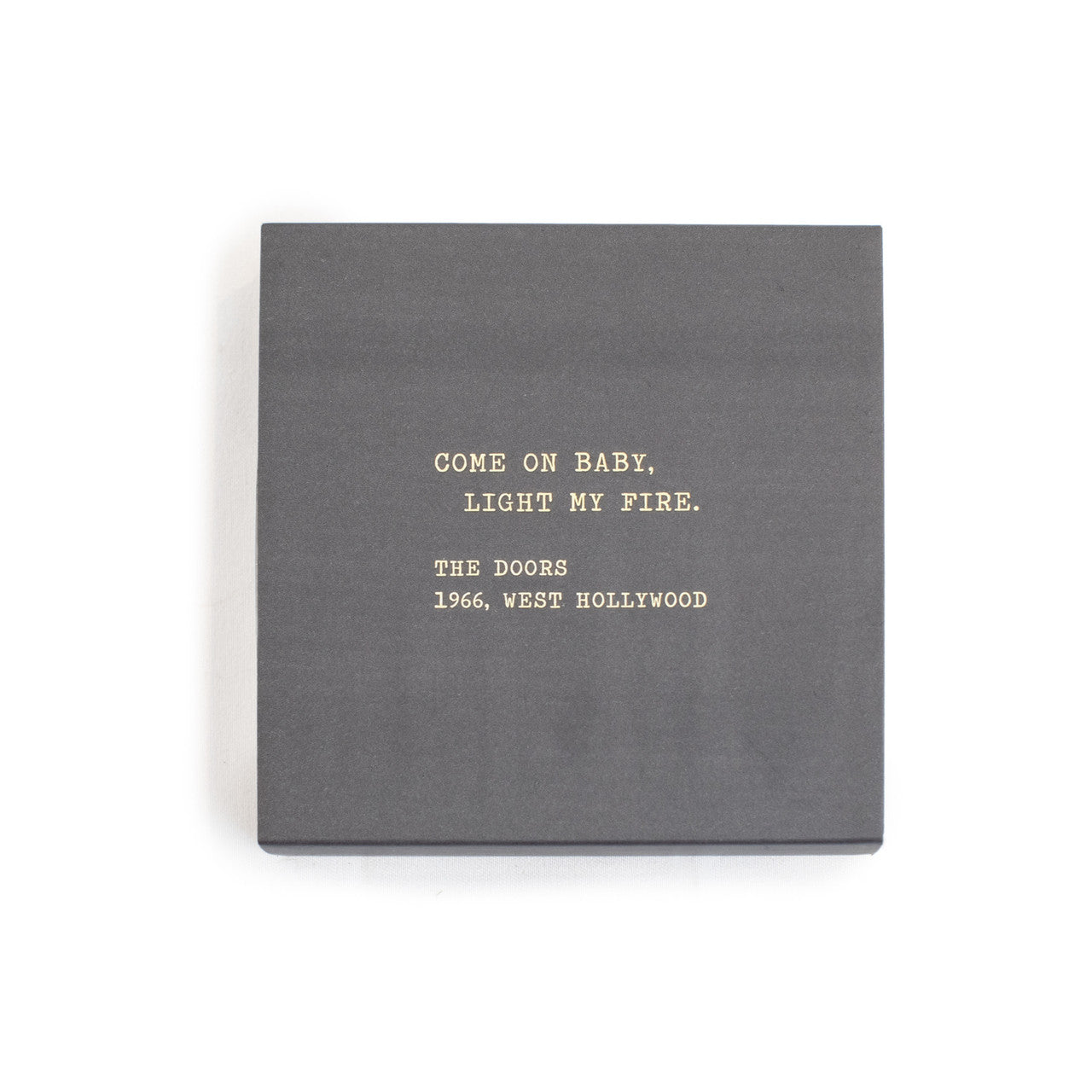 A box of matches with a gray background and a quote by The Doors written on it.