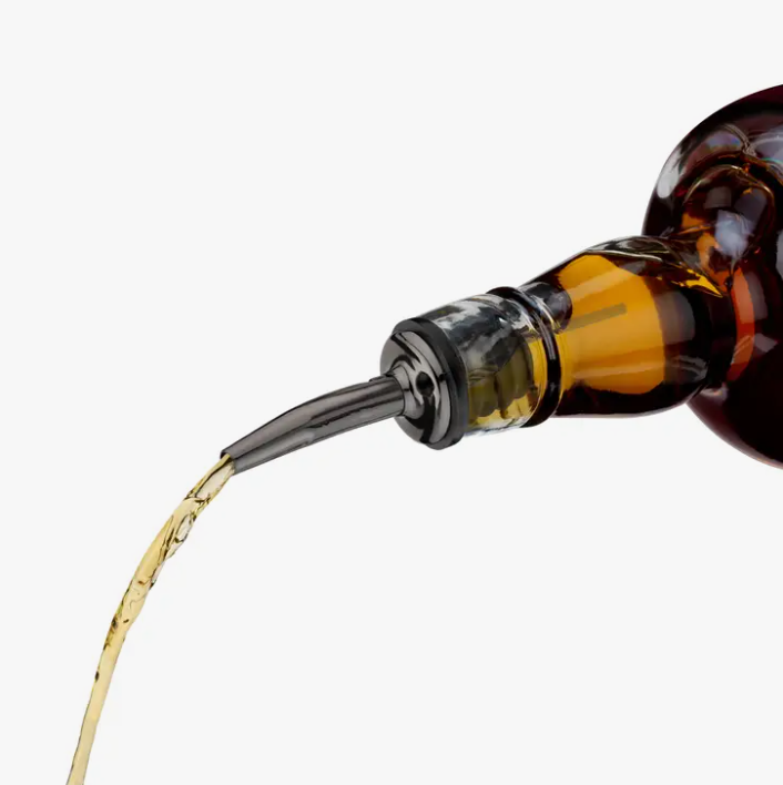 A bottle pouring alcohol using a liquor pourer spout