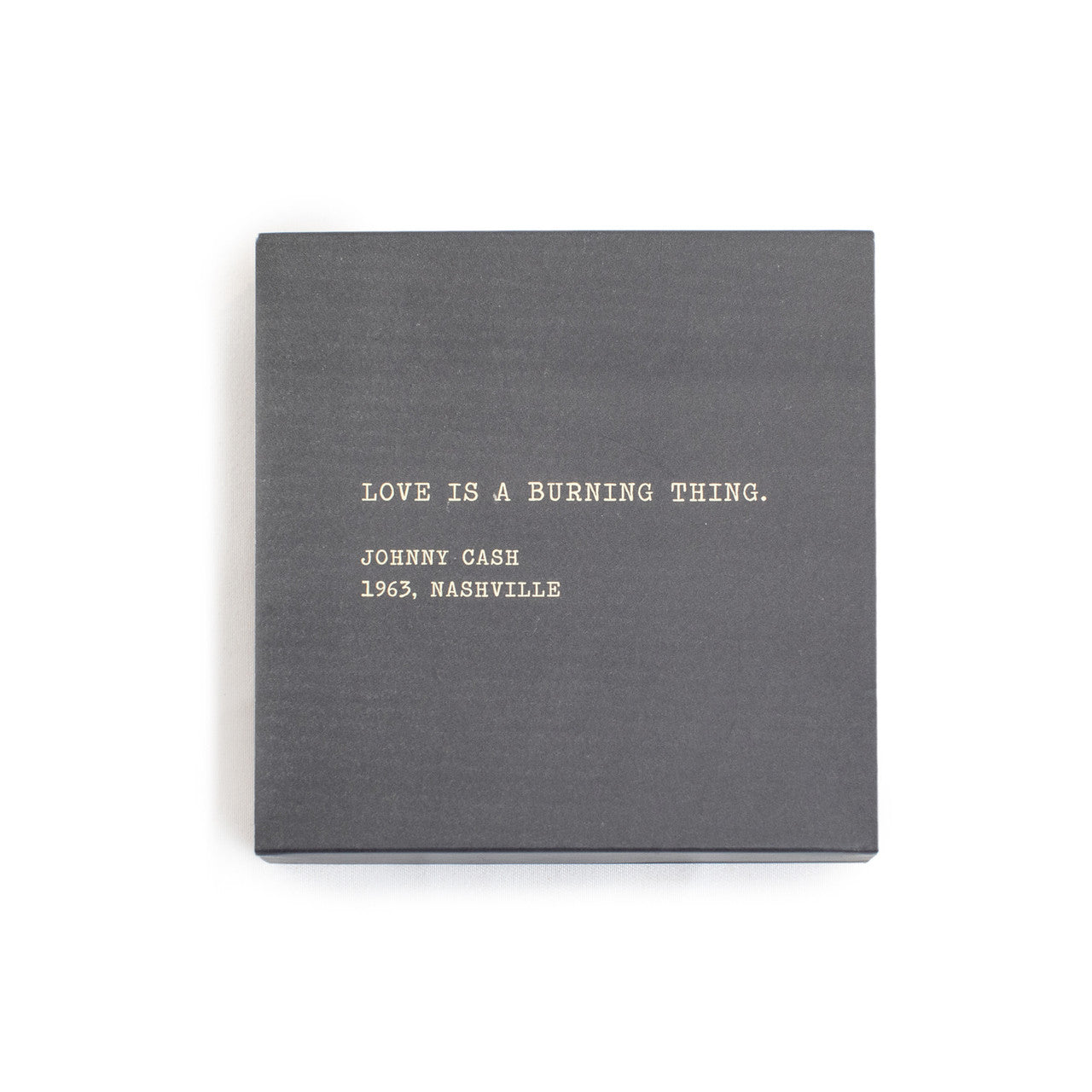 A box of matches with a gray background and a quote by Johnny Cash written on it.