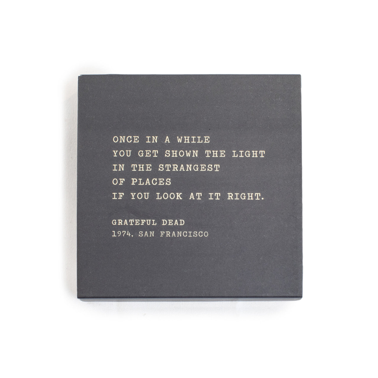 A box of matches with a gray background and a quote by the Grateful Dead written on it.