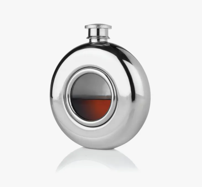 A silver flask with a circular glass center.