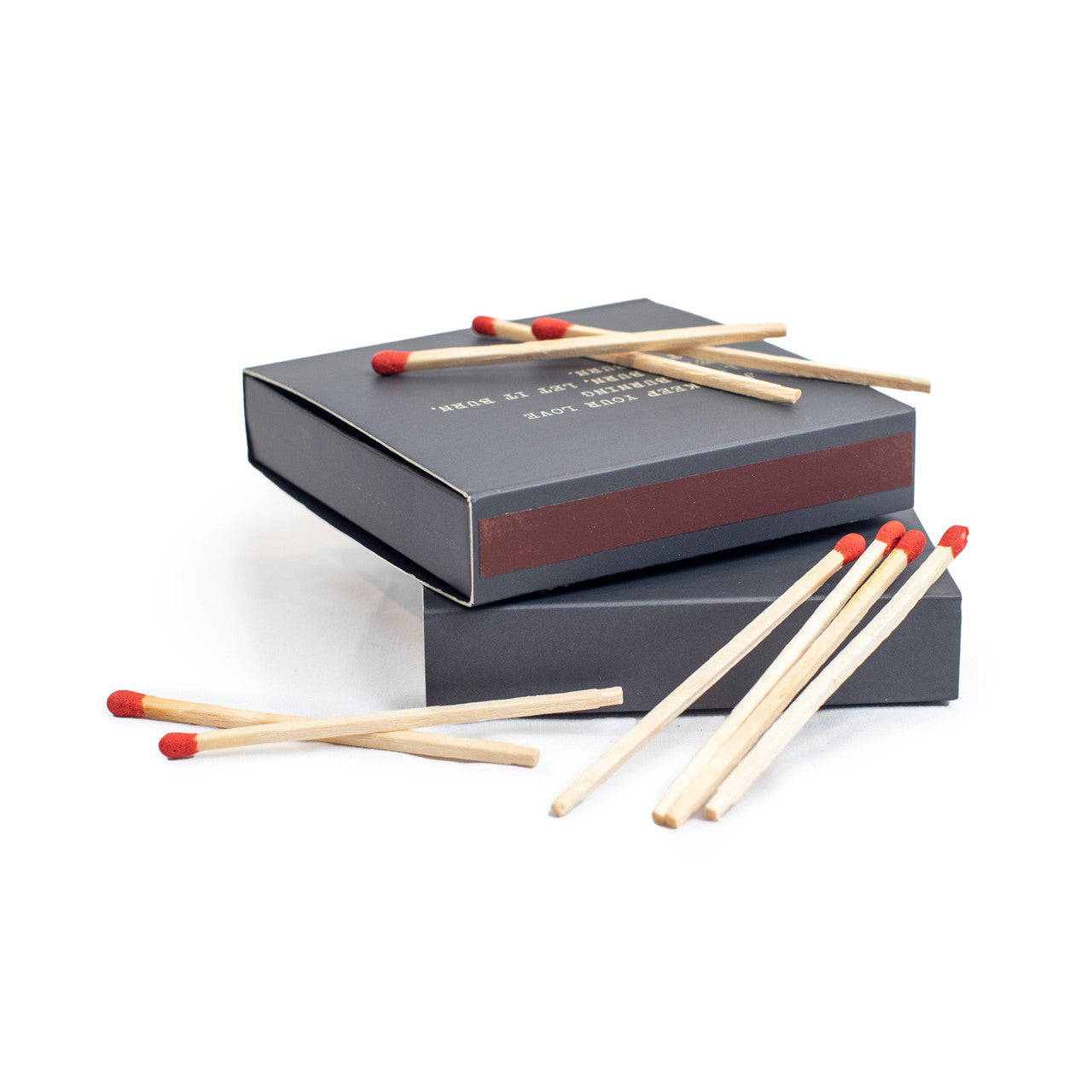 Two boxes of Legends match boxes stacked on top of each other with matches scattered around.