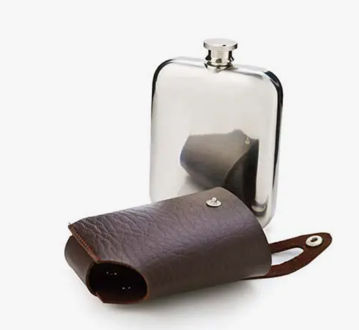 A stainless steel flask beside it's brown leather carrying case on a white background.