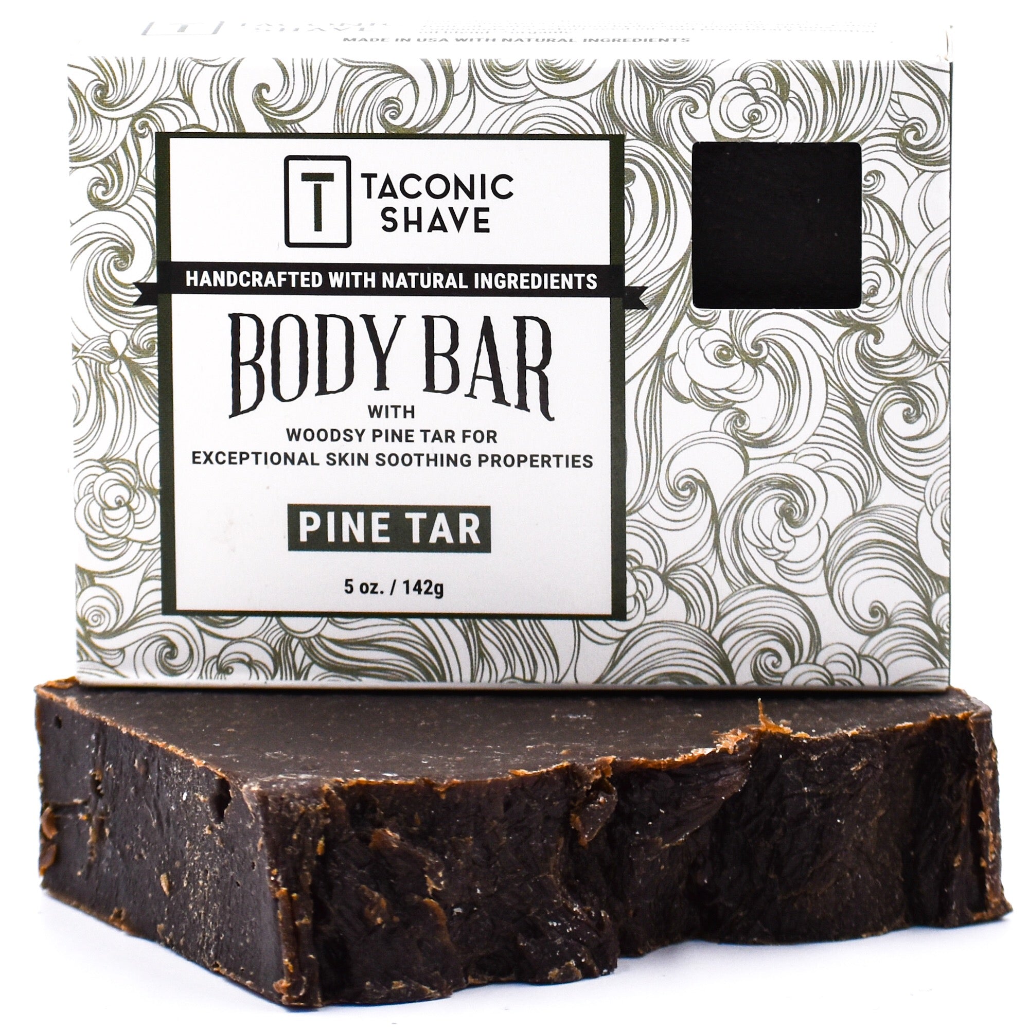 A packaged Taconic Body Soap Bar with Pine Tar scent, showing the bar of soap and its packaging with a swirl pattern and product information.