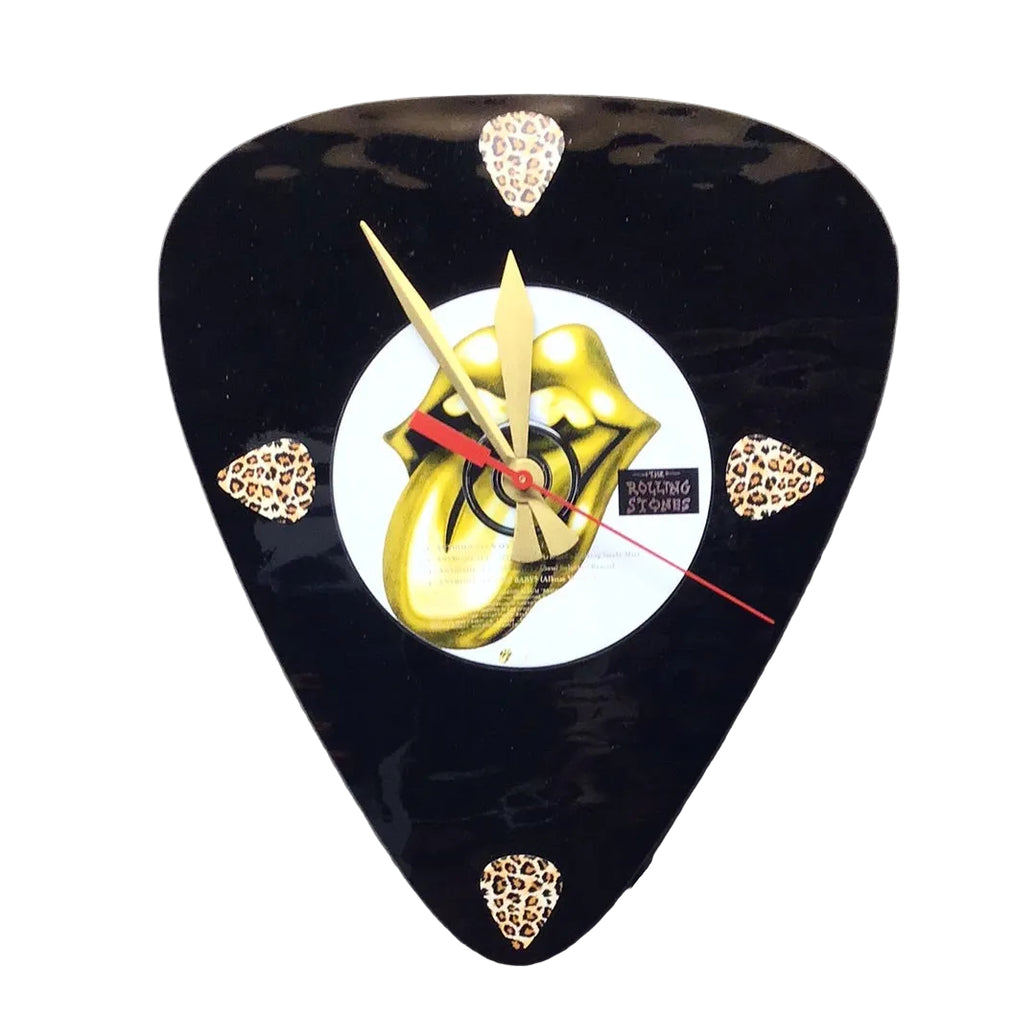 Guitar pick-shaped clock with gold Rolling Stones design in the center on a white background